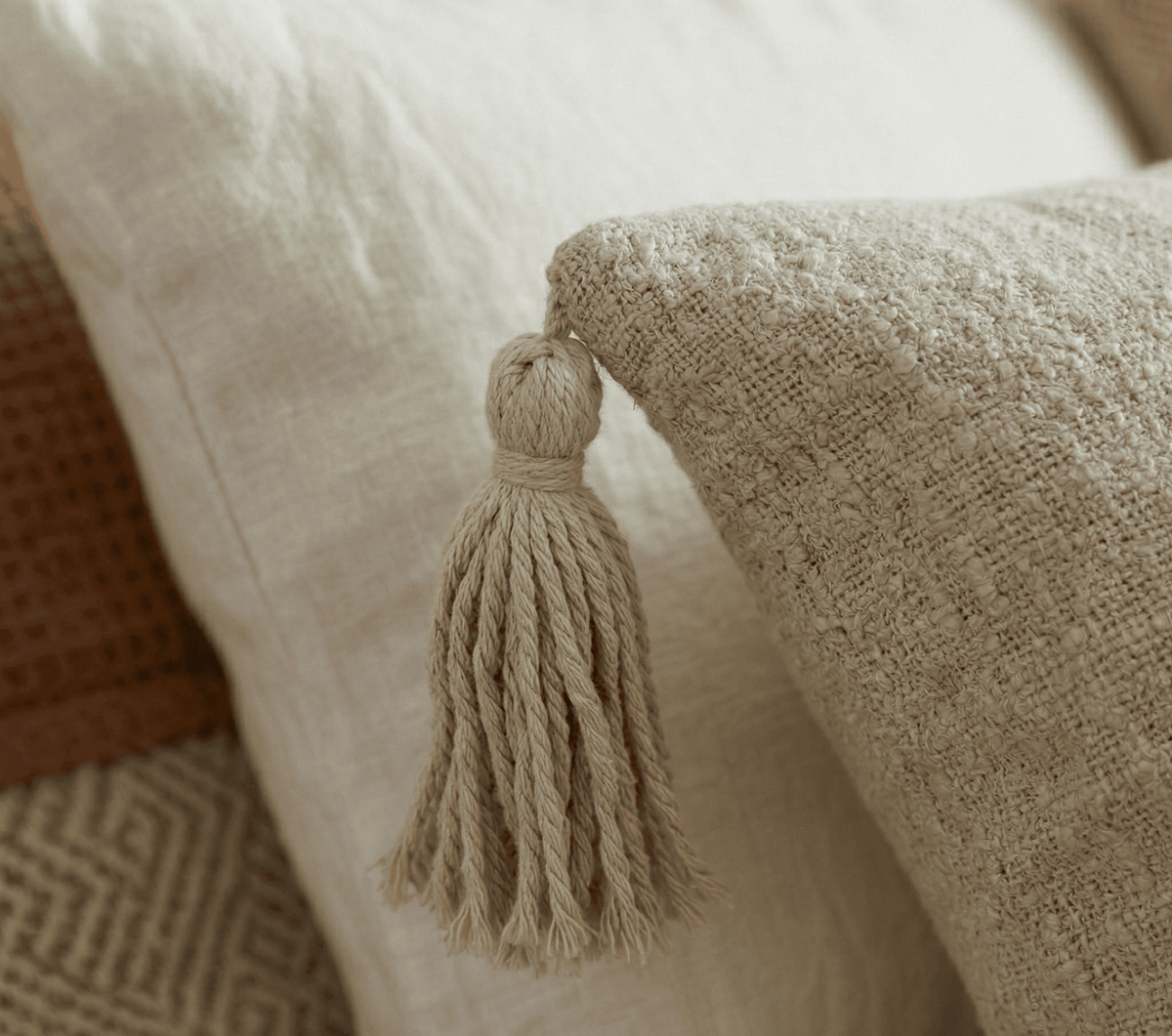 Textured beige extra long lumbar pillow cover with tassels for modern boho home decor