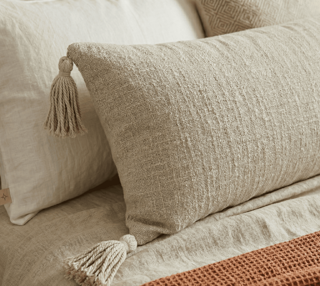 Textured beige extra long lumbar pillow cover with tassels for modern boho home decor