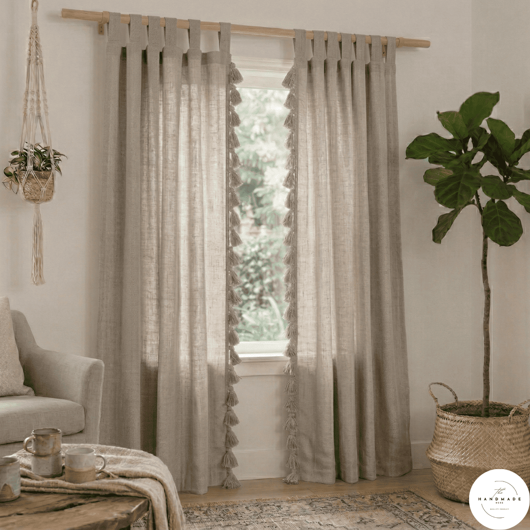 Pair of heavyweight hand-loomed Moroccan cotton curtains in oatmeal beige filtering natural light in a minimalist living room.